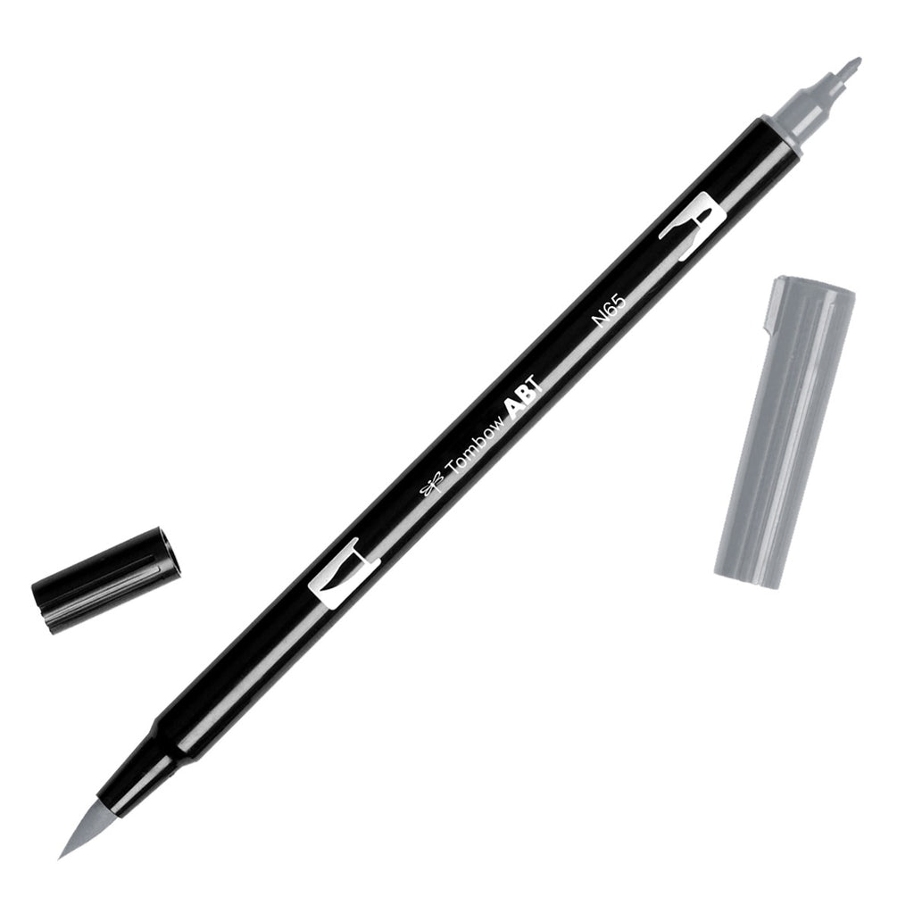 Tombow Dual Brush Art Marker, Cool Gray 5, Cloth & Paper. Art marker turned slightly to the right on a white background. It is uncapped on both ends showing the brush tip and fine tip.