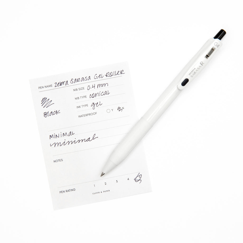 Zebra Sarasa R Pen, 0.4 mm, Black, Cloth and Paper. Pen resting on pen test sheet displaying writing sample.